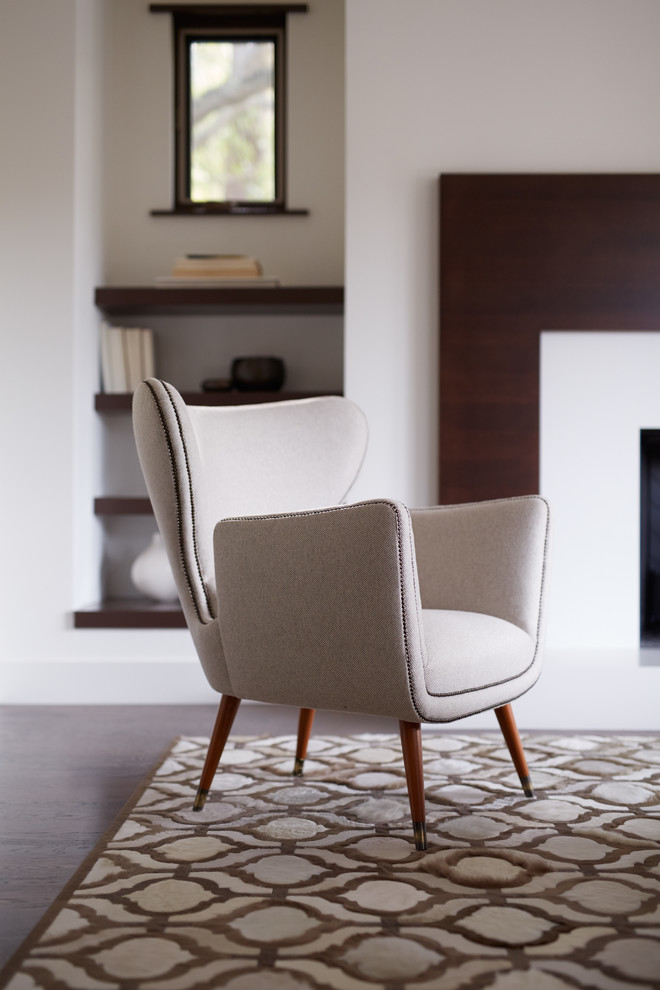 Mid-sized trendy formal and enclosed carpeted living room photo in San Francisco with white walls, a standard fireplace, a wood fireplace surround and no tv