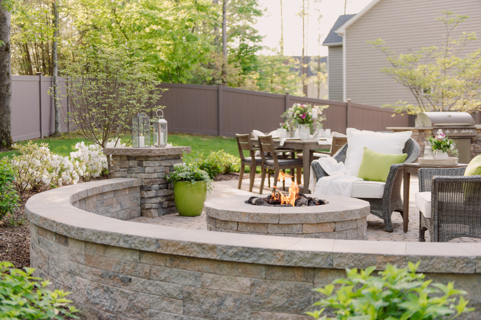Mid-sized elegant backyard concrete paver patio photo in Richmond with a fire pit and no cover