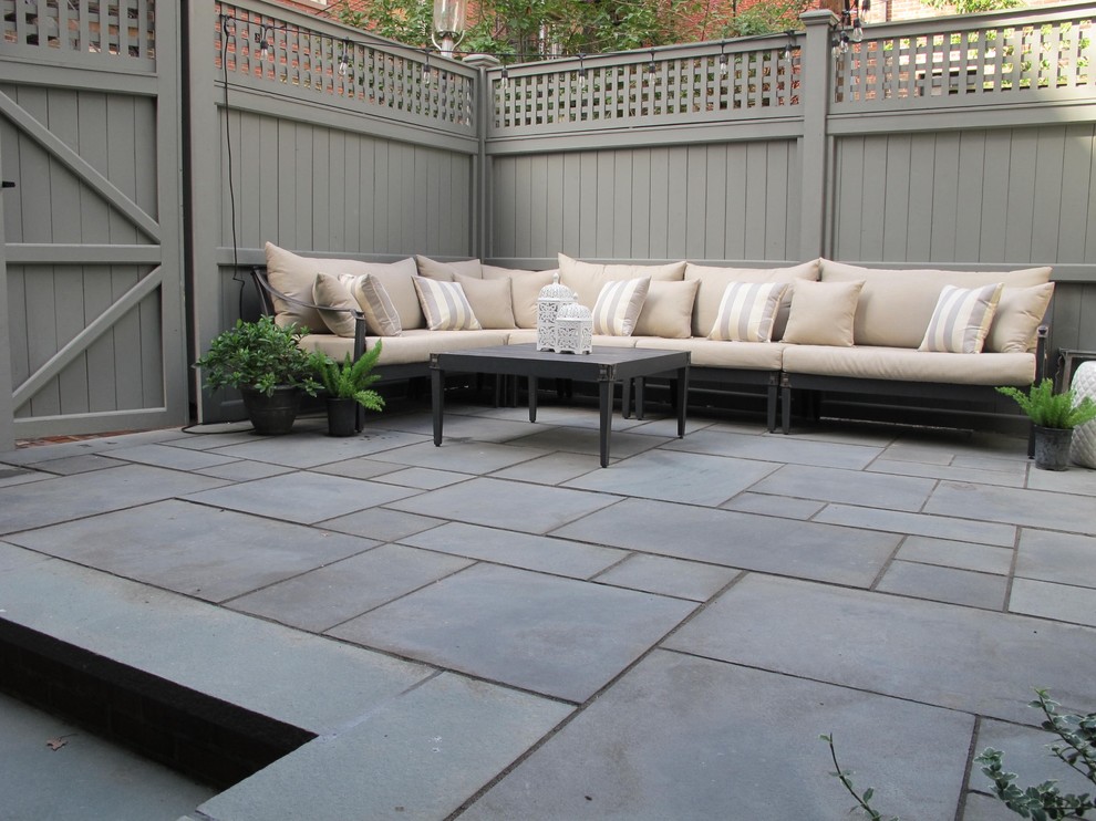 Small traditional patio in Boston with natural stone pavers.