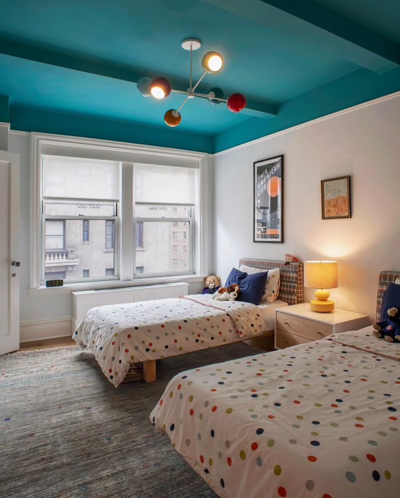 Mid-sized modern gender-neutral kids' bedroom in New York with white walls, carpet, grey floor, exposed beam and wallpaper for kids 4-10 years old.