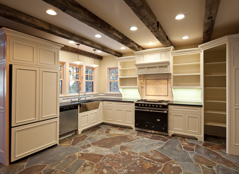 Inspiration for a mid-sized country l-shaped separate kitchen in Sacramento with a farmhouse sink, recessed-panel cabinets, white cabinets, solid surface benchtops, beige splashback, stone tile splashback, stainless steel appliances, slate floors, no island and multi-coloured floor.