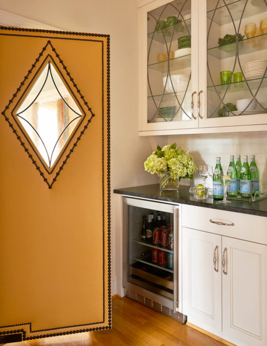 Inspiration for a large transitional u-shaped light wood floor enclosed kitchen remodel in Charlotte with a farmhouse sink, recessed-panel cabinets, white cabinets, soapstone countertops, white backsplash, subway tile backsplash and stainless steel appliances