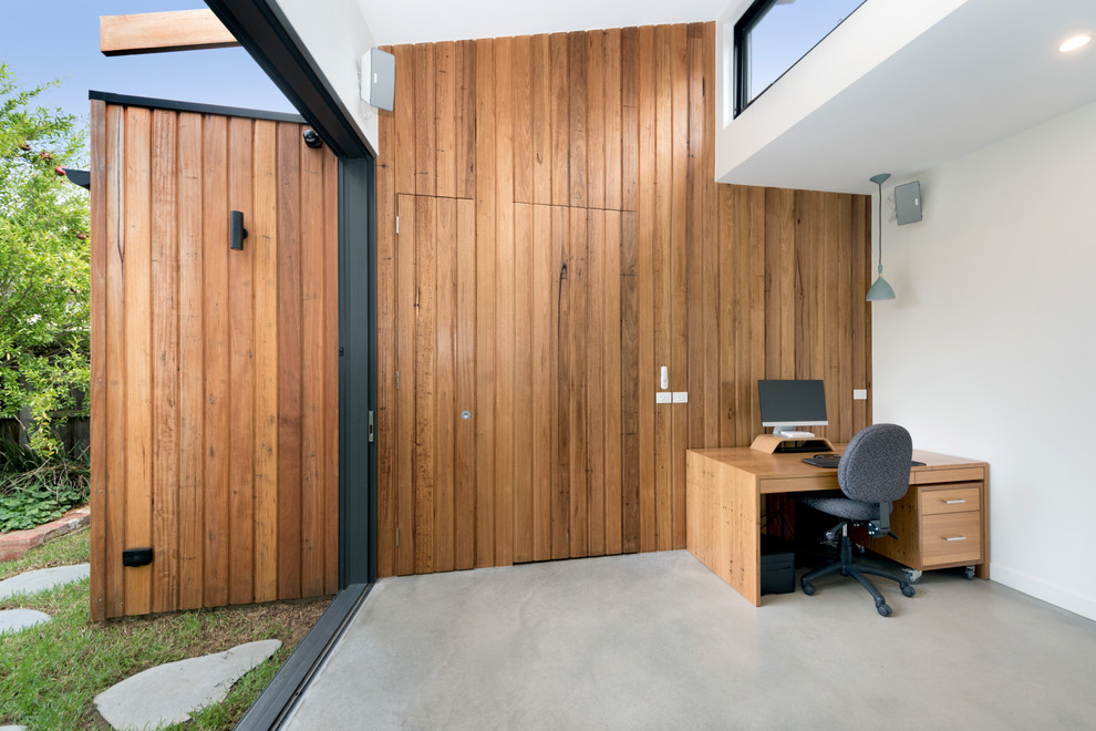 Photo of a large contemporary open concept living room in Melbourne with white walls, concrete floors, no fireplace, a built-in media wall and grey floor.