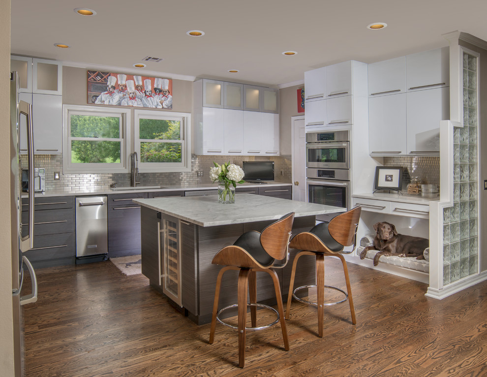 This is an example of a large contemporary u-shaped kitchen in Other with an undermount sink, flat-panel cabinets, grey cabinets, metallic splashback, stainless steel appliances, dark hardwood floors, with island, brown floor and subway tile splashback.
