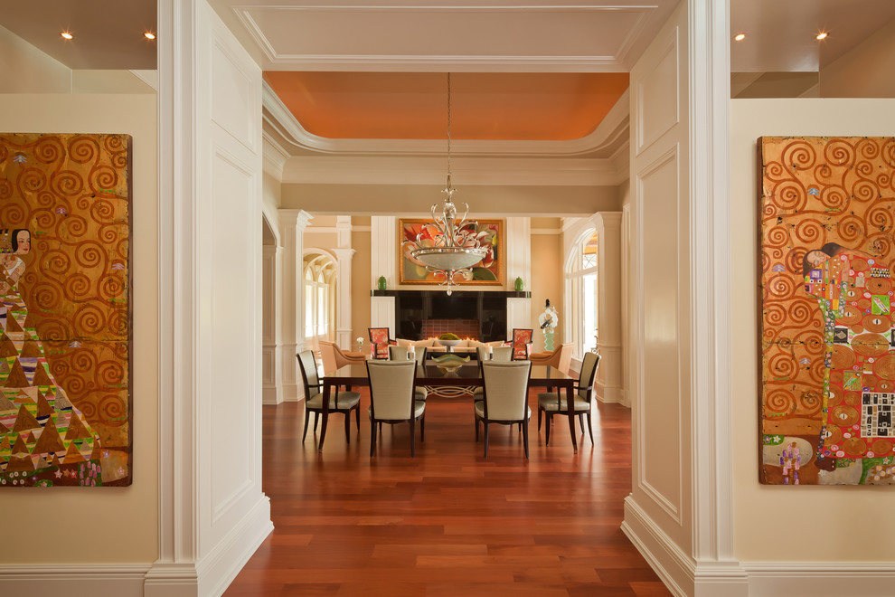Inspiration for a large traditional dining room in Miami with yellow walls, medium hardwood floors, a standard fireplace and a stone fireplace surround.