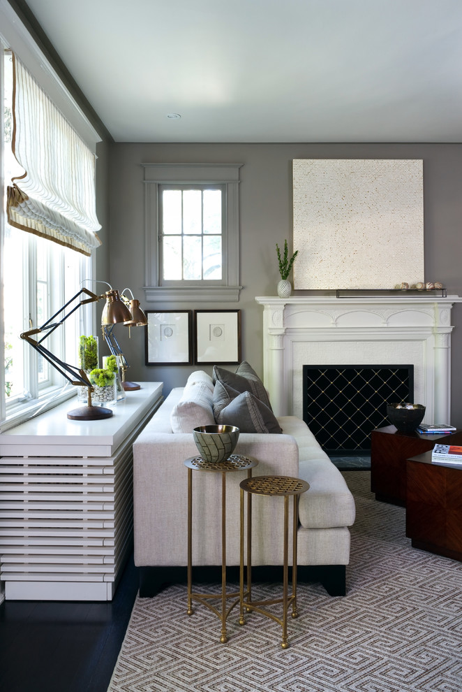 This is an example of a transitional living room in DC Metro with grey walls and a standard fireplace.