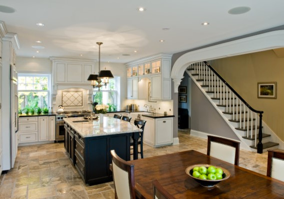Example of a transitional kitchen design in Toronto with an island, white cabinets, white backsplash, white appliances and a farmhouse sink