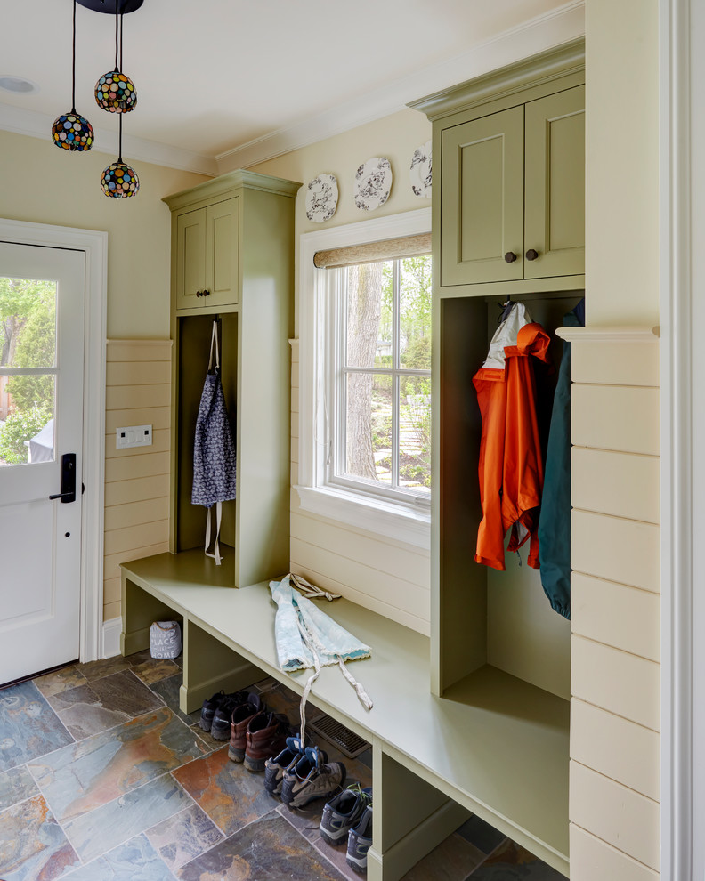 Traditional mudroom in Chicago with yellow walls, a single front door, a white front door and multi-coloured floor.