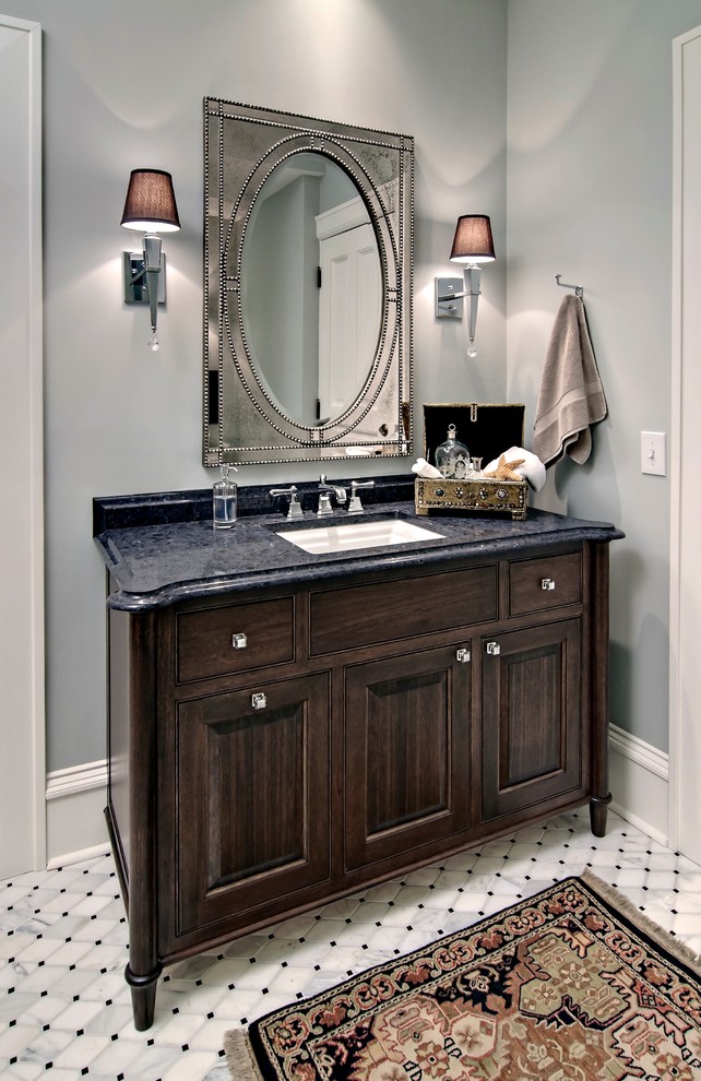 Mid-sized traditional 3/4 bathroom in Minneapolis with an undermount sink, furniture-like cabinets, dark wood cabinets, engineered quartz benchtops, gray tile, stone tile, grey walls and marble floors.