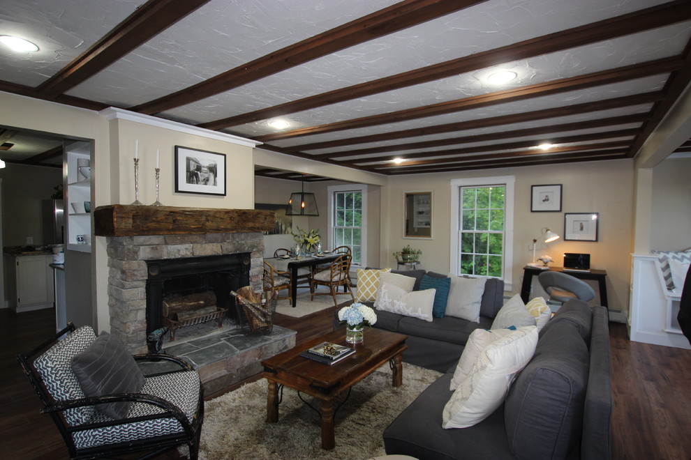 Photo of a mid-sized traditional open concept living room in Portland Maine with beige walls, medium hardwood floors, a standard fireplace and a stone fireplace surround.