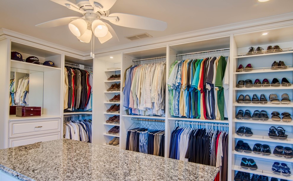 Inspiration for a large traditional gender-neutral walk-in wardrobe in Orange County with open cabinets and white cabinets.