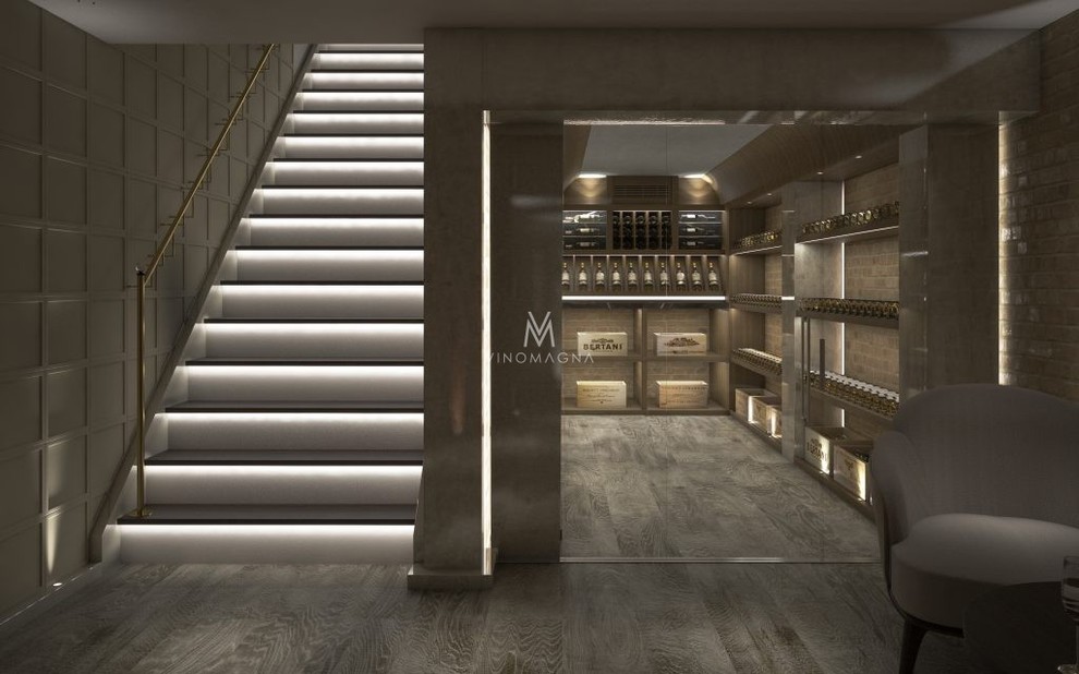 Large rustic wine cellar in London with display racks, light hardwood flooring, beige floors and a feature wall.