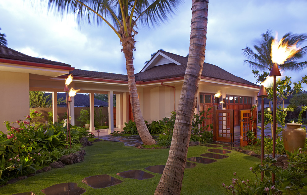 Large tropical two-storey stucco beige exterior in Hawaii.