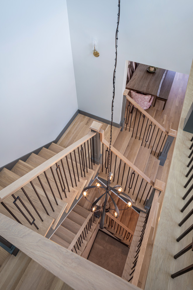 Design ideas for a transitional wood u-shaped staircase in Denver with painted wood risers and wood railing.