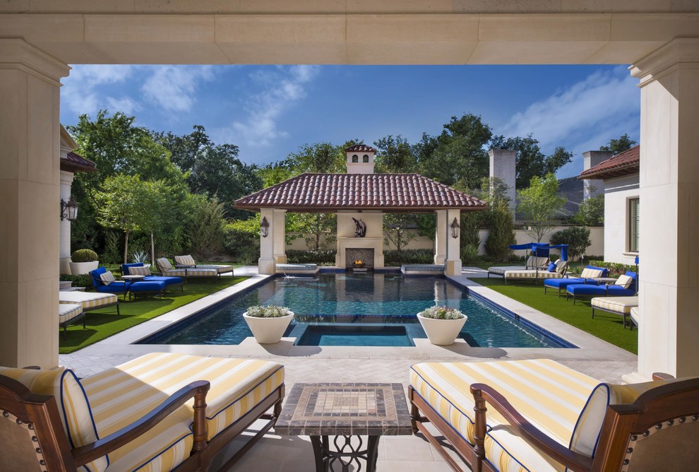 Mediterranean backyard rectangular pool in Dallas with a hot tub and concrete pavers.