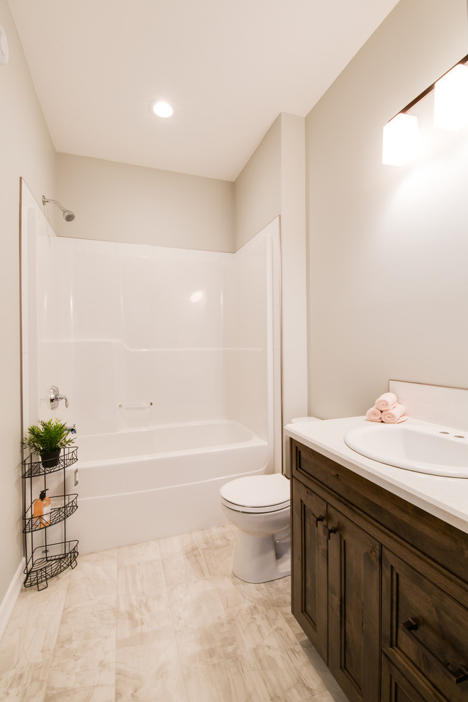 Bathroom - mid-sized transitional bathroom idea with shaker cabinets, dark wood cabinets, a drop-in sink and laminate countertops
