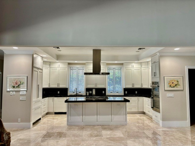 Kitchen - transitional u-shaped marble floor kitchen idea with a single-bowl sink, white cabinets, quartzite countertops and black countertops