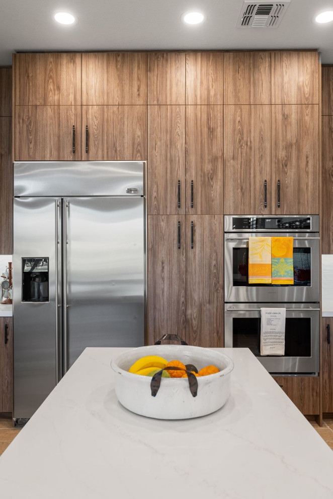 Mountain style l-shaped slate floor and beige floor enclosed kitchen photo with a single-bowl sink, flat-panel cabinets, medium tone wood cabinets, quartzite countertops, white backsplash, glass sheet backsplash, stainless steel appliances, a peninsula and white countertops