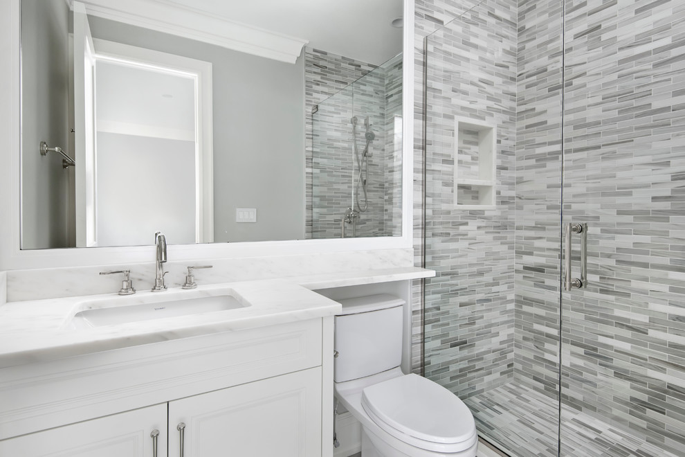 Small transitional kids' multicolored tile and mosaic tile marble floor alcove shower photo in Chicago with an undermount sink, recessed-panel cabinets, white cabinets, marble countertops, a two-piece toilet and gray walls