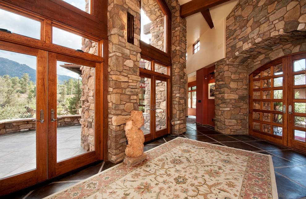 Foyer - huge transitional concrete floor foyer idea in Phoenix with beige walls and a medium wood front door