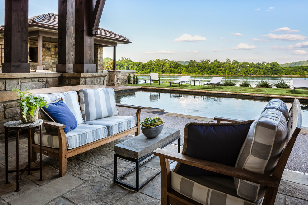 Large mountain style backyard stone and rectangular natural hot tub photo
