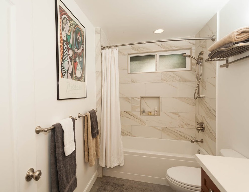 Inspiration for a small traditional bathroom in San Diego with an undermount sink, shaker cabinets, medium wood cabinets, engineered quartz benchtops, a freestanding tub, a shower/bathtub combo, a one-piece toilet, white tile, porcelain tile, white walls and porcelain floors.