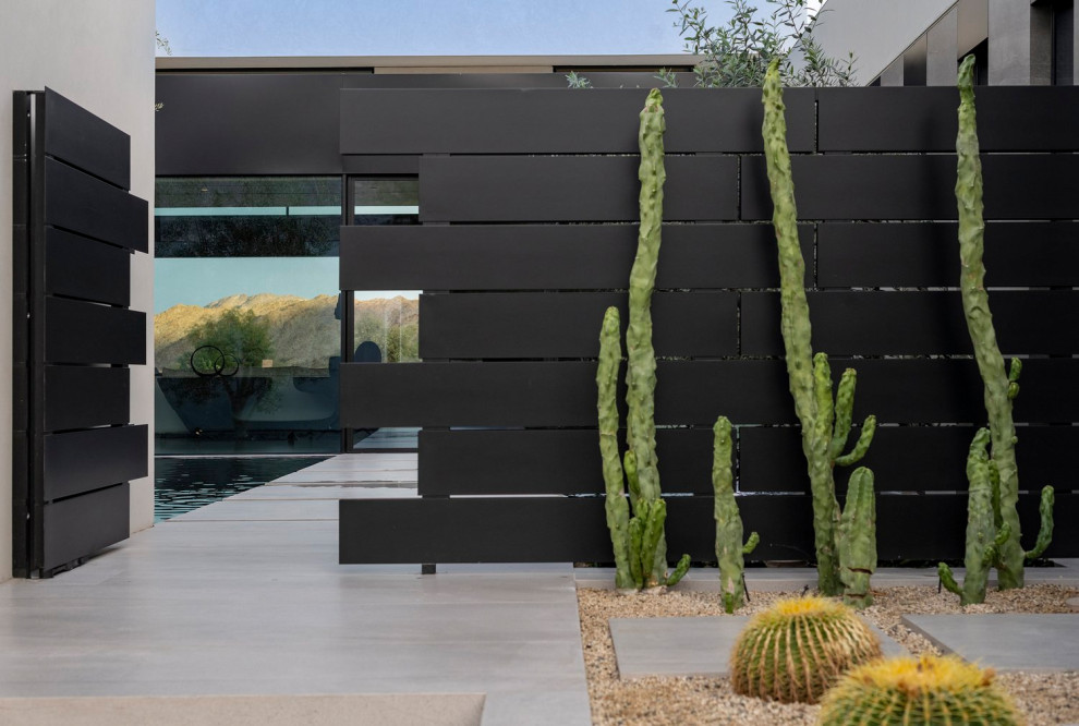 Ispirazione per un piccolo giardino minimalista esposto in pieno sole davanti casa con ghiaia e recinzione in legno