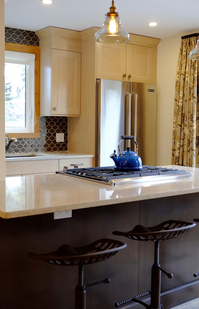 Example of a transitional kitchen design in Calgary