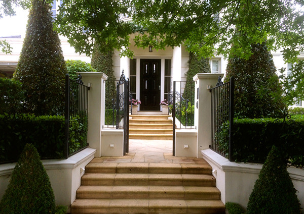 This is an example of a front yard formal garden in Melbourne with natural stone pavers.
