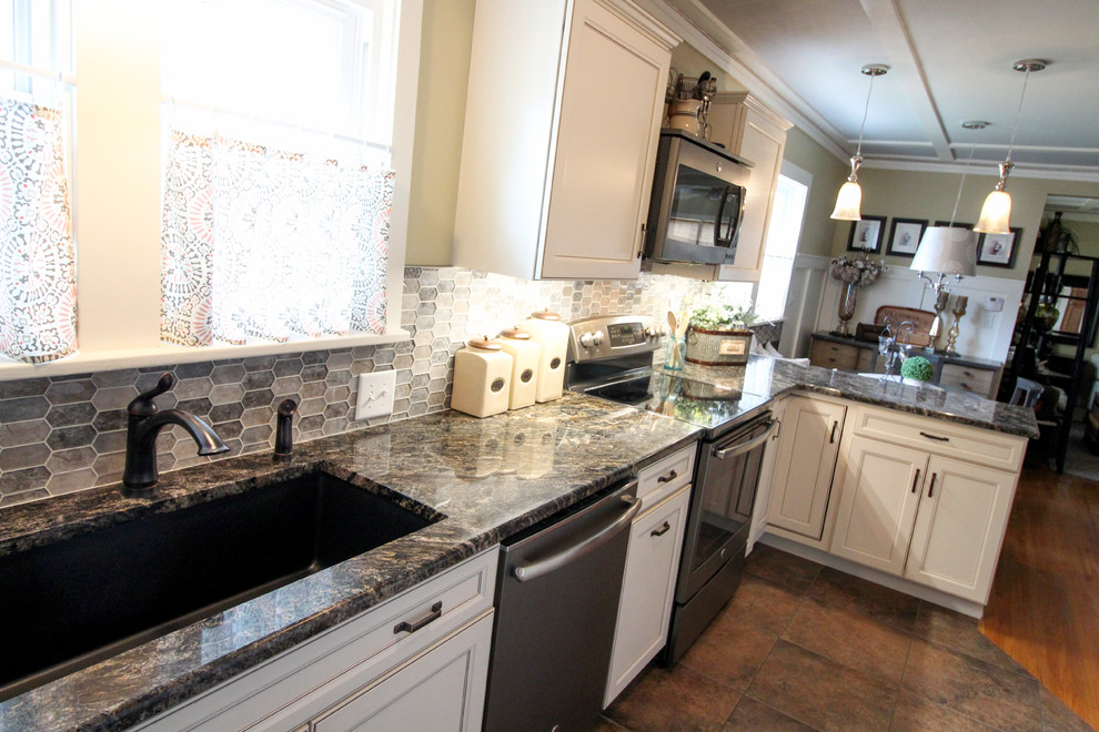 Inspiration for a transitional multicolored floor kitchen remodel with an undermount sink, recessed-panel cabinets, white cabinets, granite countertops, multicolored backsplash, mosaic tile backsplash, stainless steel appliances and black countertops