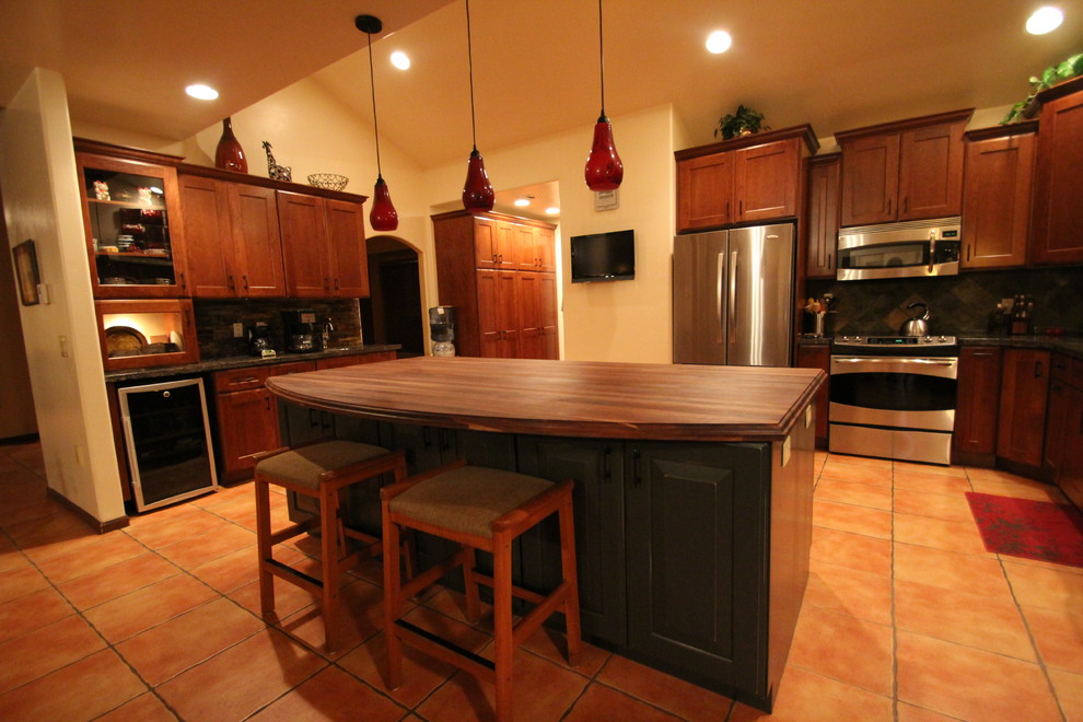 Inspiration for a mid-sized transitional terra-cotta tile open concept kitchen remodel in Phoenix with recessed-panel cabinets, medium tone wood cabinets, multicolored backsplash, stone tile backsplash, stainless steel appliances and an island