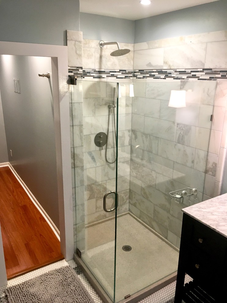 Inspiration for a mid-sized contemporary bathroom in Minneapolis with furniture-like cabinets, brown cabinets, a corner shower, a two-piece toilet, gray tile, marble, grey walls, laminate floors, an integrated sink, marble benchtops, orange floor, a hinged shower door and grey benchtops.