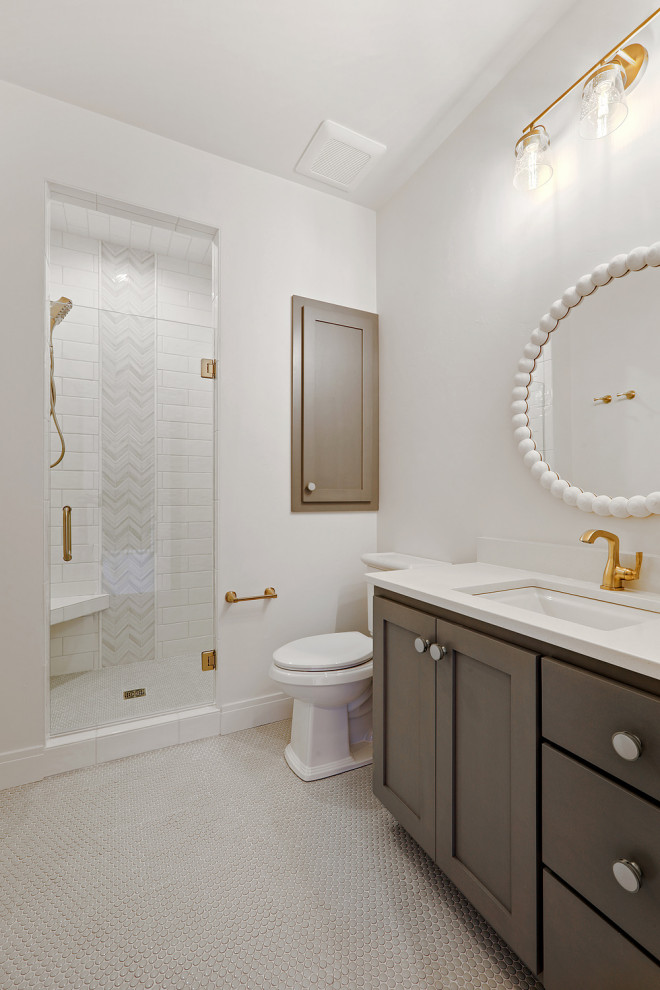 Example of a mid-sized transitional kids' white tile and porcelain tile porcelain tile, green floor and single-sink doorless shower design with shaker cabinets, brown cabinets, a one-piece toilet, white walls, an undermount sink, quartz countertops, a hinged shower door, white countertops and a built-in vanity