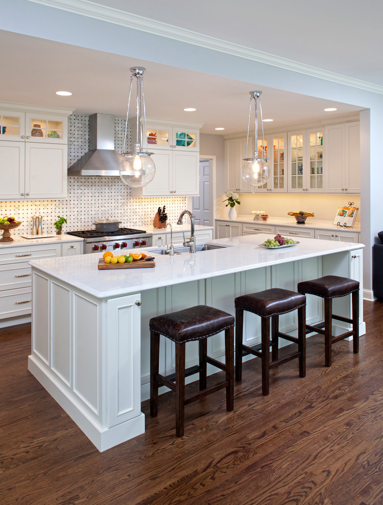 Inspiration for a large transitional galley dark wood floor open concept kitchen remodel in Minneapolis with an undermount sink, recessed-panel cabinets, white cabinets, quartzite countertops, white backsplash, mosaic tile backsplash, stainless steel appliances and an island