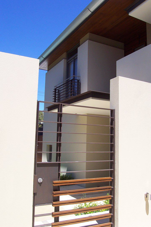 Inspiration for a large contemporary two-storey stucco beige exterior in Newcastle - Maitland.