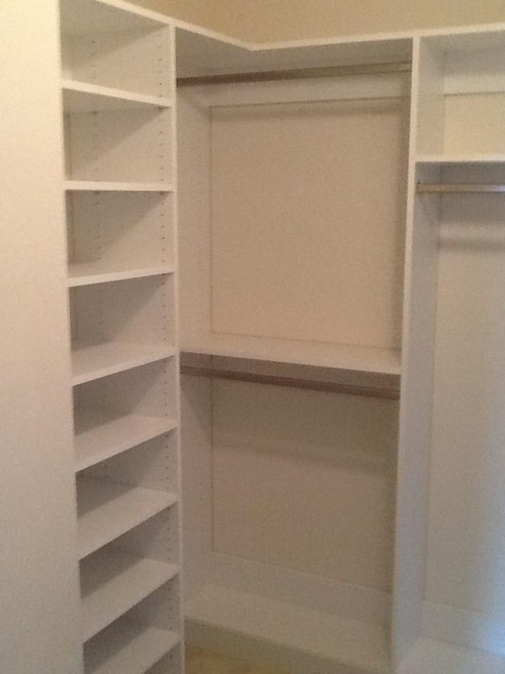 Large traditional gender-neutral walk-in wardrobe in Richmond with white cabinets and open cabinets.