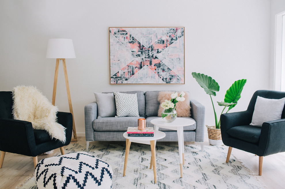 Scandinavian formal living room in Sydney with grey walls and light hardwood floors.