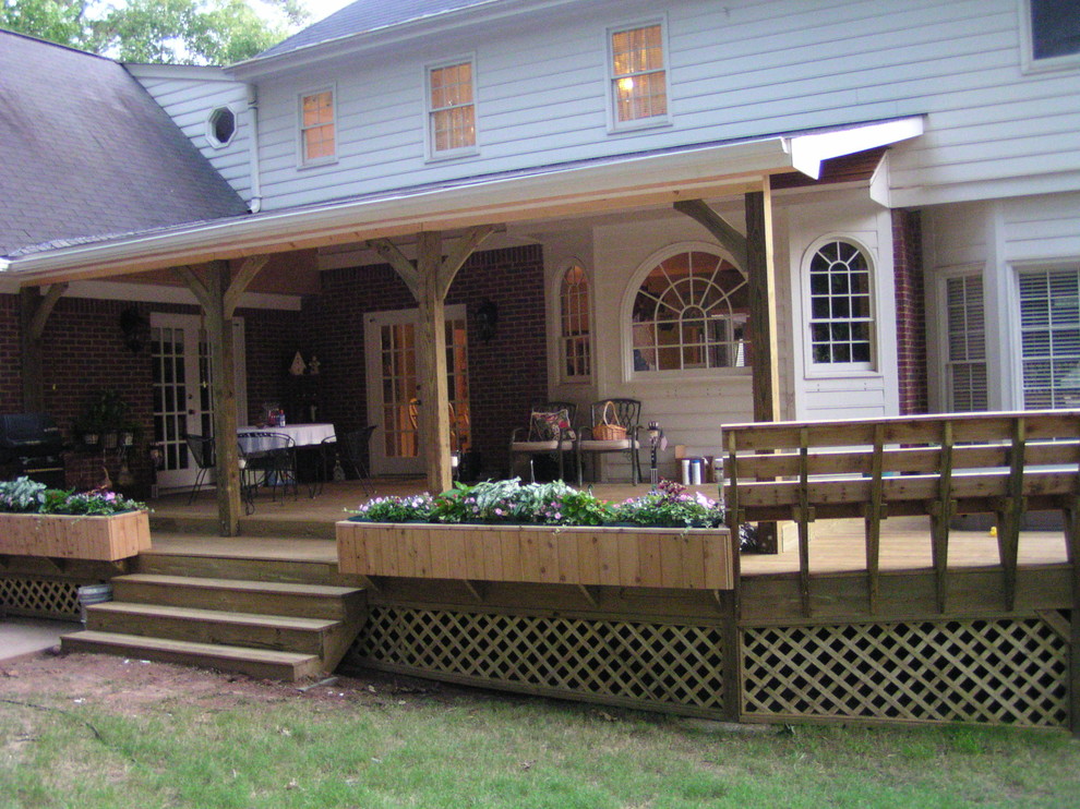 Large mountain style backyard deck container garden photo in Atlanta with a roof extension