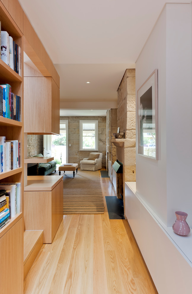 Modern hallway in Sydney with white walls and light hardwood floors.