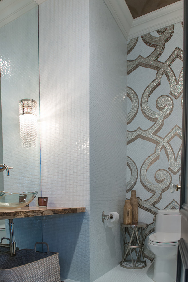 Inspiration for an eclectic powder room in New York with a vessel sink, white walls and porcelain floors.