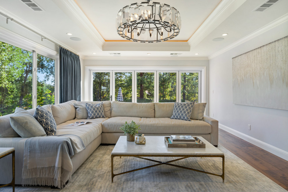 Mid-sized transitional enclosed living room in San Francisco with medium hardwood floors, a built-in media wall and coffered.