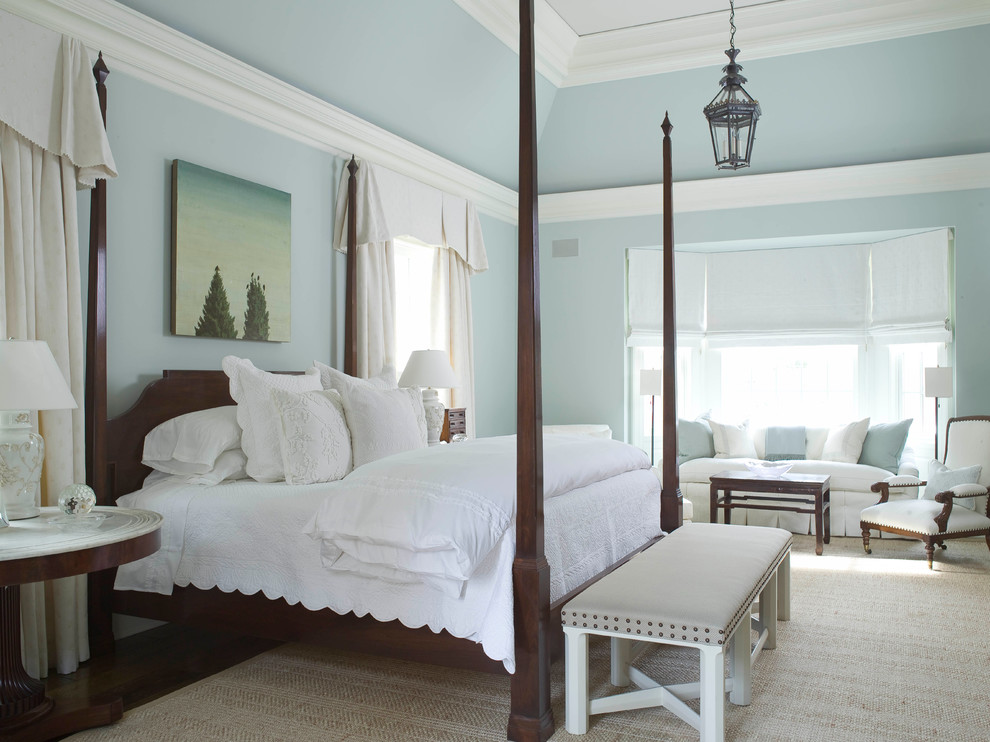 Large traditional master bedroom in New York with blue walls and dark hardwood floors.