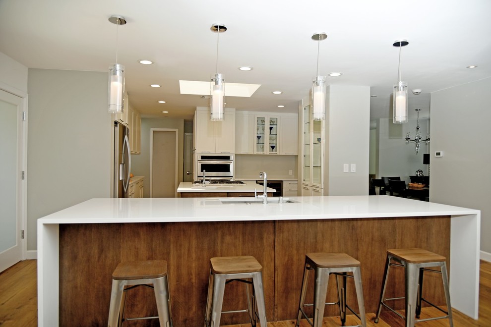 Large transitional eat-in kitchen photo in Los Angeles with an undermount sink, shaker cabinets, quartz countertops, stainless steel appliances, two islands and distressed cabinets