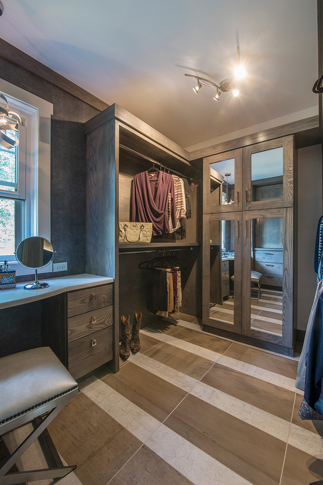 Design ideas for a large country gender-neutral walk-in wardrobe in Other with open cabinets, dark wood cabinets and brown floor.