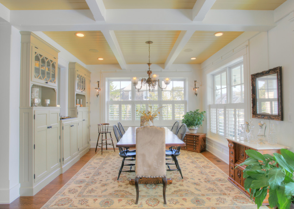 Photo of a traditional dining room in Bridgeport with white walls and medium hardwood floors.