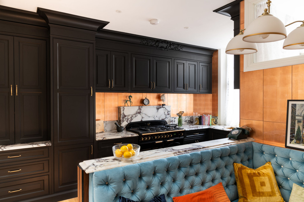 Inspiration for a small traditional u-shaped separate kitchen in London with an integrated sink, raised-panel cabinets, black cabinets, quartzite benchtops, white splashback, engineered quartz splashback, black appliances, medium hardwood floors, brown floor and white benchtop.