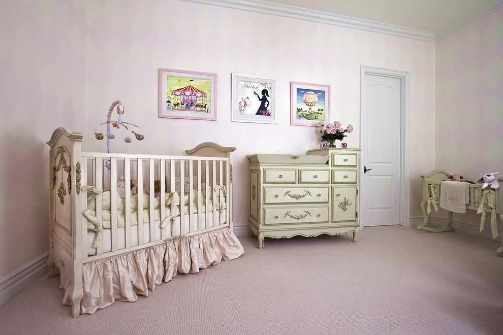 Design ideas for a traditional nursery for girls in Phoenix with pink walls, carpet and beige floor.