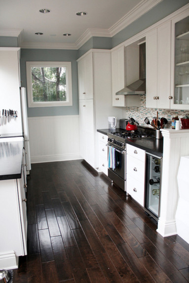 Blue gray kitchen with black counter tops and white ...