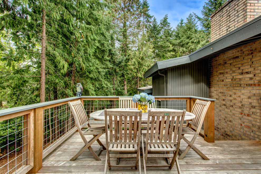 Minimalist backyard deck photo in Seattle with a roof extension