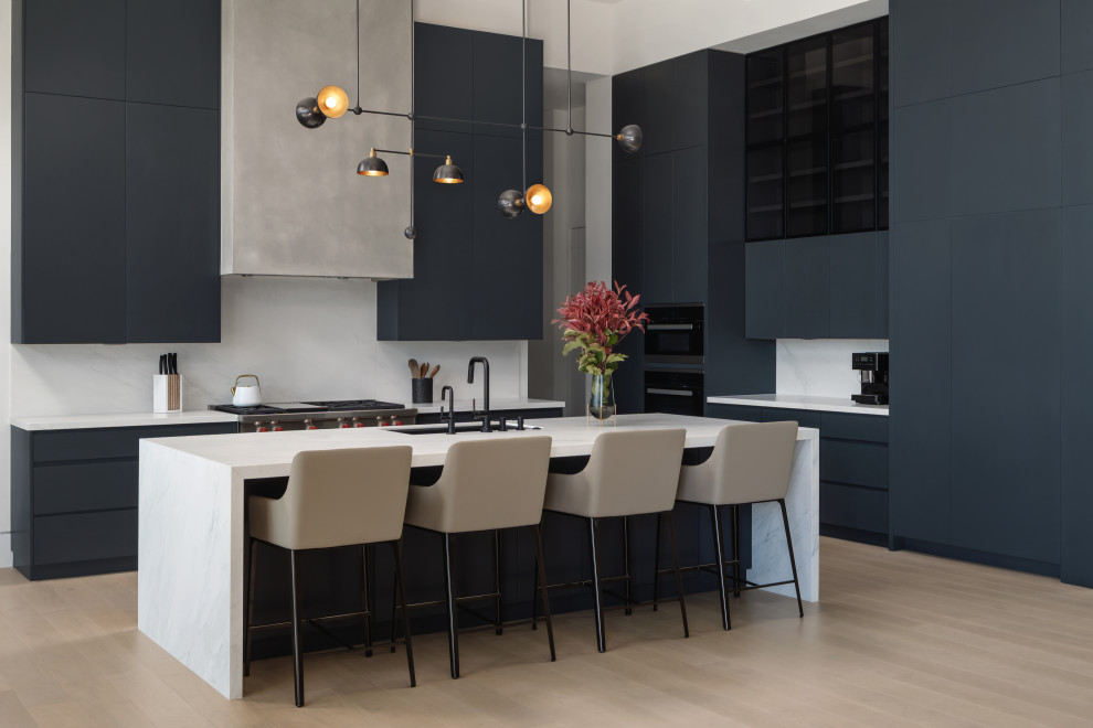 Inspiration for a modern single-wall beige floor eat-in kitchen remodel in Austin with a drop-in sink, blue cabinets, white backsplash, black appliances and an island